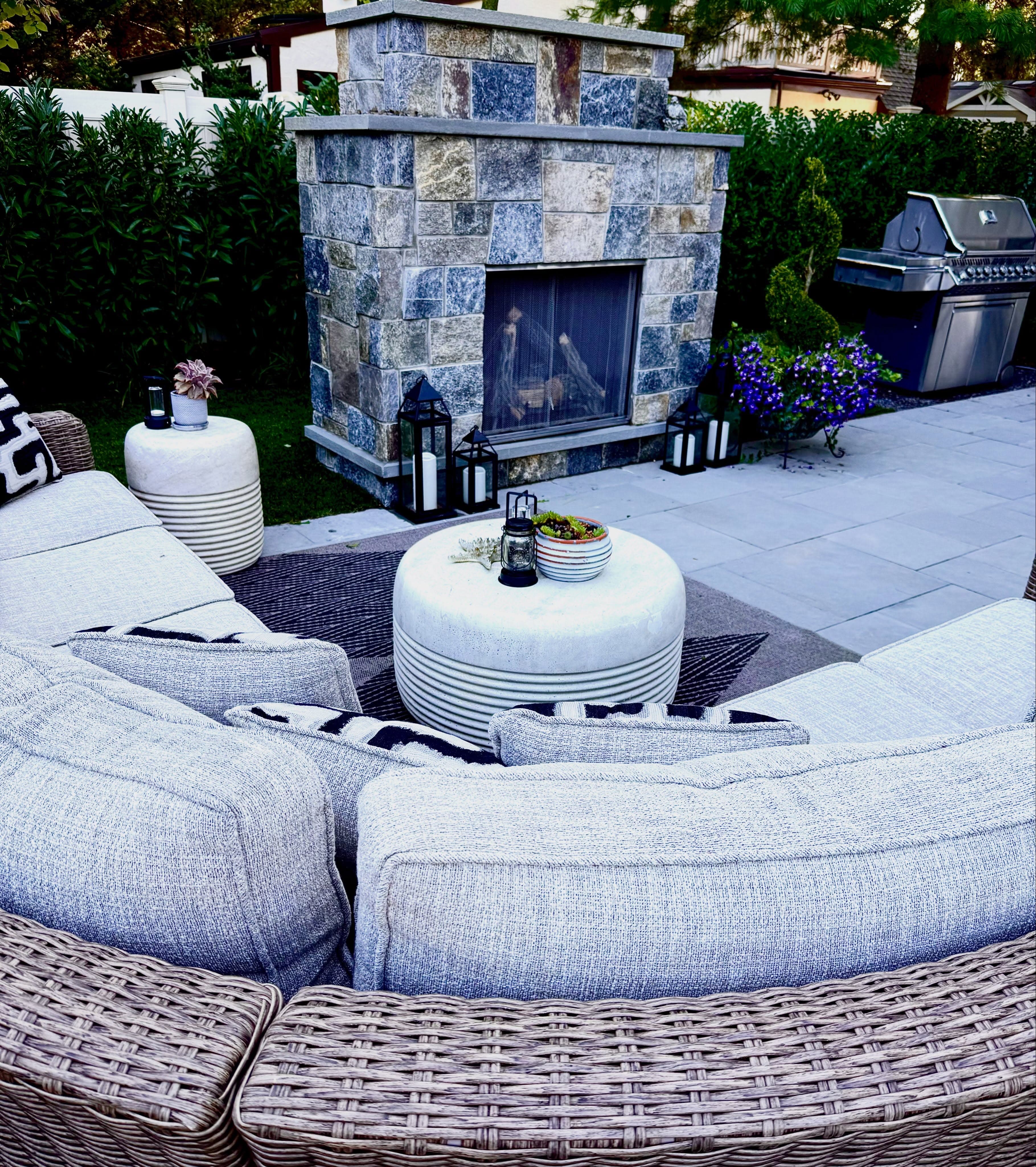 Custom stone outdoor fireplace with seating