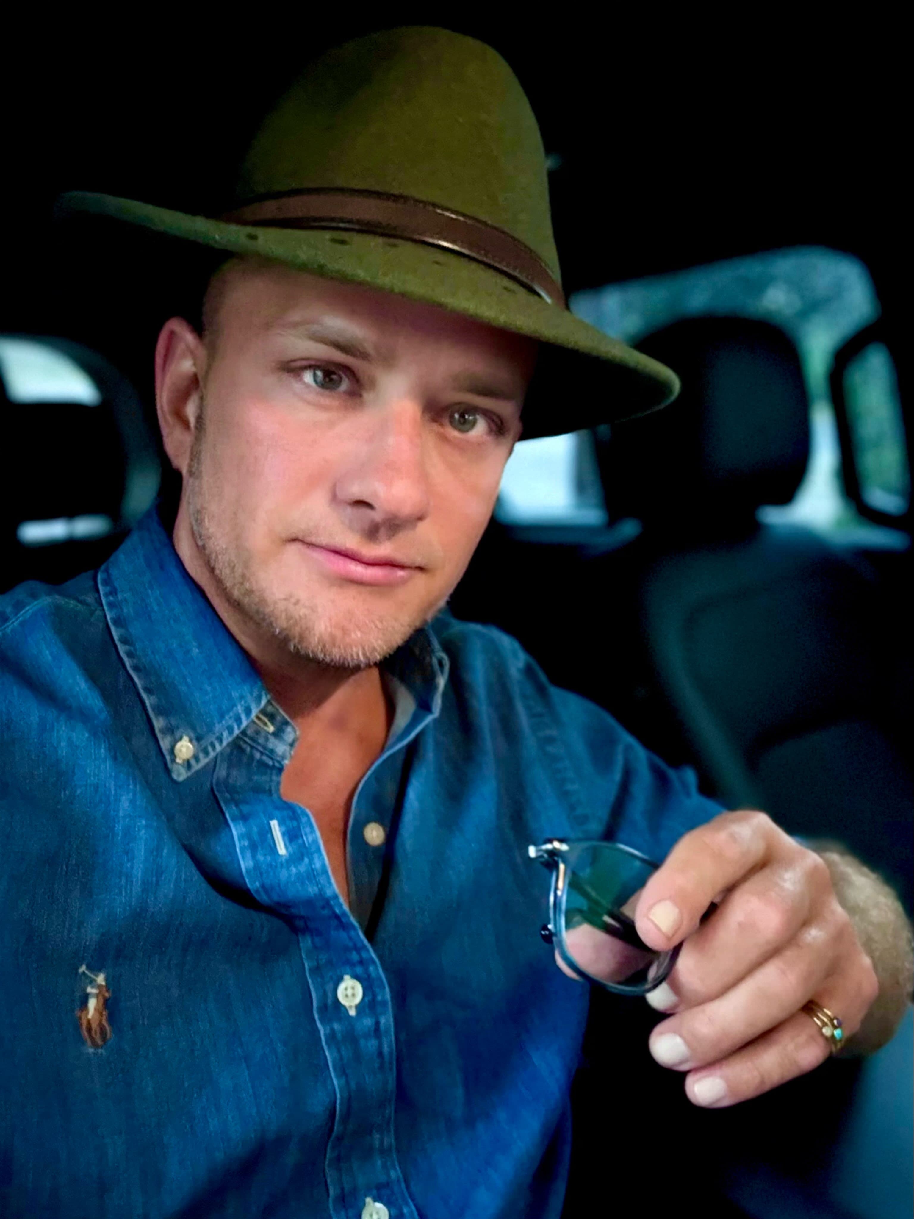 Joseph DeVito portrait, olive hat, denim shirt